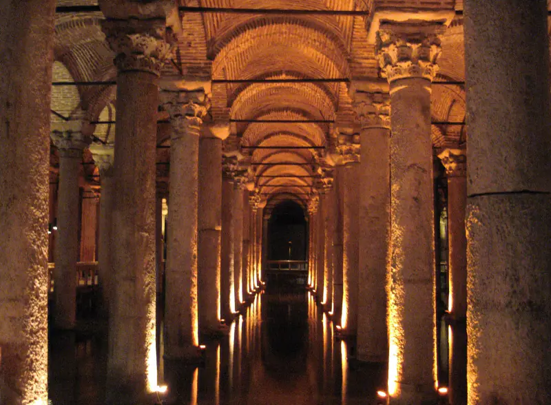 Columns lit in the dark water of the Basilica Cistern