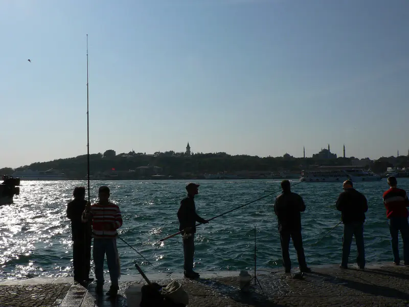 Fishermen with their lines over the rail of the Galata Bridge
