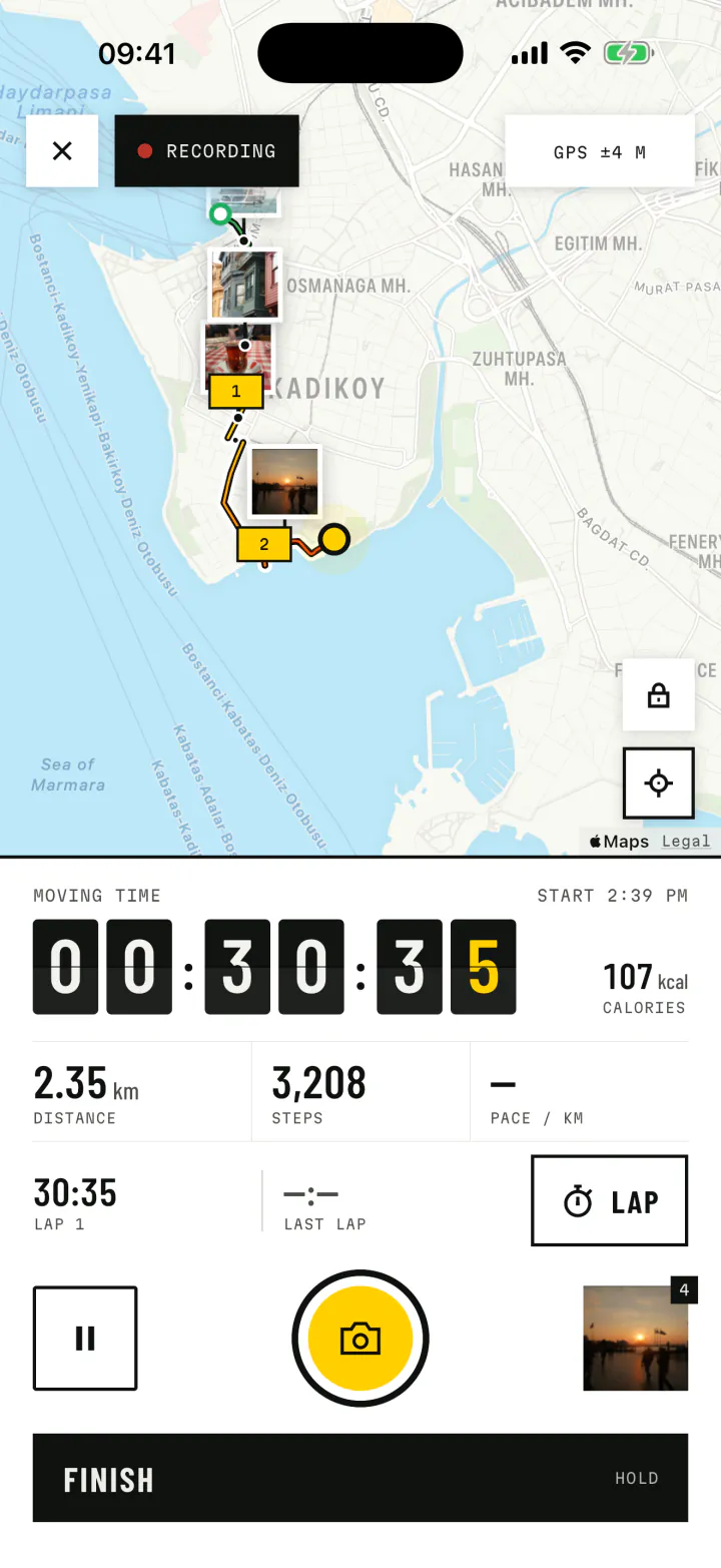 A live walk in Istanbul: the route on the map with photo prints, a split-flap timer at 00:30:35 and a yellow camera button